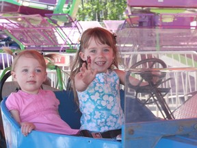 The Smith sisters, Sage, 2, and Skye, 3, enjoyed some of the carnival rides during the sunny Saturday afternoon. - Karen Haynes, Reporter/Examiner