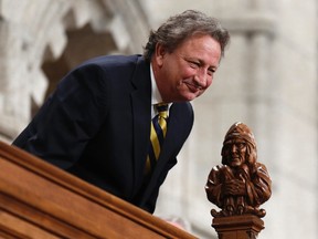 Ottawa Senators owner Eugene Melnyk reacts while being recognized by the Speaker in the House of Commons on Parliament Hill in Ottawa March 4, 2014. (REUTERS)