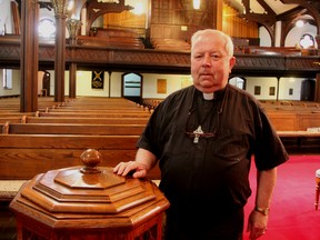 Rev. Lloyd Murdock stands next to the baptismal font at St. Andrew's Presbyterian Church. The historical Sarnia church will be one of the locations offering tours during a Doors Open event being held June 21 and 22 across Lambton County. (PAUL MORDEN, The Observer)
