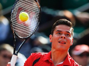 Milos Raonic hits a return to Gilles Simon during their men's singles match at the French Open in Paris May 30, 2014. (GONZALO FUENTES/Reuters)