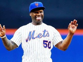 Rap artist 50 Cent reacts after throwing the ceremonial first pitch before a game between the New York Mets and the Pittsburgh Pirates at Citi Field on May 27, 2014 in the Flushing neighborhood of the Queens borough of New York City. (Jim McIsaac/Getty Images/AFP)