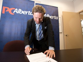Edmonton-Castle Downs MLA Thomas Lukaszuk smiles signs a receipt for filing his nomination papers at the Progressive Conservative Association of Alberta office at 9823- 103 Street in Edmonton, Alta., on Friday, May 30, 2014, to join the race for the leadership of the Progressive Conservative Party. Ian Kucerak/Edmonton Sun