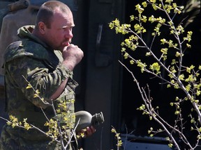 A Canadian soldier brushes his teeth outside a LAV III military vehicle during the Exercise Maple Resolve training mission at CFB Wainwright in Wainwright, AB on Wednesday May 28, 2014. Over 4,500 Canadian Armed Forces members were joined by 400 United States soldiers and roughly 100 soldiers from Britain in Canada's largest training exercise of the year. Trevor Robb/Edmonton Sun/QMI Agency