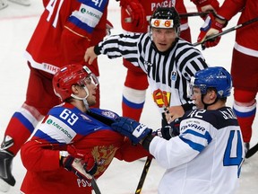 Russia's Alexander Burmistrov (L) fights with Finland's Jere Sallinen (R) during the second period of their men's ice hockey World Championship group B game at Minsk Arena in Minsk May 11, 2014.  REUTERS/Alexander Demianchuk (BELARUS  - Tags: SPORT ICE HOCKEY)