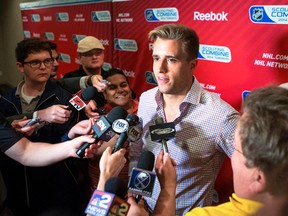 Young defenceman Aaron Ekblad speaks is surrounded by reporters -- including the Sun's Mike Zeisberger (right) in Toronto at the NHL Scouting Combine. (Ernest Doroszuk/Toronto Sun)