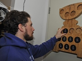 Toronto Marlies defenceman Andrew MacWilliam mounts puck No. 9 (one for each playoff win) on to a plaque following Thursday’s victory over the Texas Stars. (Brad White/photo)