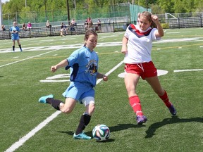JOHN LAPPA/THE SUDBURY STAR      
Courtney Sauve, left, of College Notre Dame, and Erin Herbert, of Widdifield Secondary School chase after the ball during the girls NOSSA AAA soccer finals at James Jerome Sports Complex in Sudbury on Friday.