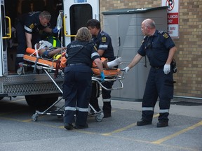 Paramedics rush a shooting victim to hospital on May 30, 2014. (Victor Biro/Special to the Toronto Sun)