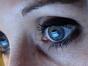 An illustration picture shows a woman looking at the Facebook website on a computer in Munich in this February 2, 2012 file photo. REUTERS/Michael Dalder/Files