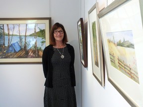 Terri Jackson shows off some of the work on display at the Gallery in the Grove in Brights Grove. The Sarnia Artists Workshop is hosting a show to celebrate their 50th anniversary. BRENT BOLES / SARNIA OBSERVER