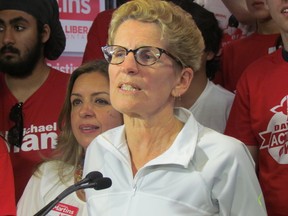 Premier Kathleen Wynne jogs to Liberal youth rally Saturday May 31, 2014. Wynne criticized NDP Leader Andrea Horwath's apparent openness to supporting a minority PC government. (Toronto Sun/Antonella Artuso)