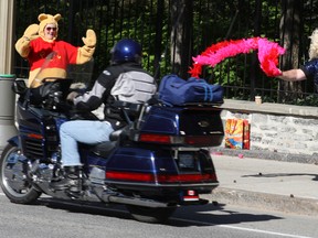 Joseph "Dolly" Cull and Jill "Pooh" Hardy cheer the motorcyclists as they roll by 24 Sussex Dr. Saturday, May 31, 2014. More than 1,600 people took part in the annual Ride For Dad, which was estimated to raise in excess of $375,000.
DOUG HEMPSTEAD/Ottawa Sun/QMI AGENCY
