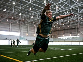 Eskimos Mike Miller performs a long jump during training camp medicals (Codie McLachlan, Edmonton Sun).