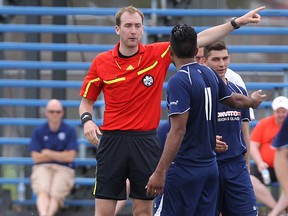 At the 2014 Charity Shield game at Winnipeg Soccer Complex on Saturday, May 31, referee Graham Forsyth ejects a player from Lucania FC for accumulating two yellow cards. (KEVIN KING/Winnipeg Sun)
