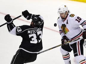 Chicago Blackhawks winger Patrick Sharp (10) watches the puck as Los Angeles Kings defenceman Willie Mitchell (33) skates around the goal during the third period in of Game 6. (USA Today Sports)