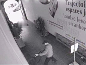 This videograb released on May 25, 2014, by the Belgian federal police on demand of Brussels' king prosecutor, shows the suspect of the killings in the Jewish Museum on May 24,2014 in Brussels. Belgian police hunted down a gunman who shot dead three people including two Israelis in an attack on the Brussels Jewish Museum reviving fears of a fresh wave of anti-Semitism in Europe. A fourth victim died on Sunday. POLICE  HAND OUT