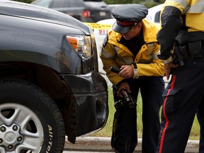 Edmonton Police Service major collision investigation unit officers investigate after a woman was sent to hospital after a collision with a Toyota Tundra pickup truck at 170 Street and 95 Avenue in Edmonton, Alta., on Saturday, May 31, 2014. Ian Kucerak/Edmonton Sun/QMI Agency