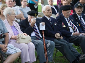 First Hussars D-Day veterans William Reed, left, Aris Domnas, Arthur Boyle and Philip Cockburn were among more than 200 people who attended the annual D-Day reunion ceremony at Victoria Park Sunday. (DEREK RUTTAN/ The London Free Press)