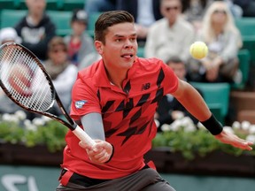 Milos Raonic of Canada hits a return to Marcel Granollers of Spain during their men's singles match at the French Open tennis tournament at the Roland Garros stadium in Paris June 1, 2014. (REUTERS)