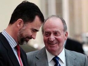 Spanish King Juan Carlos talks to his son Crown Prince Felipe during the Spanish National Sport Awards ceremony at El Pardo Palace outside Madrid in this February 28, 2011 file photo. (REUTERS/Susana Vera/Files)