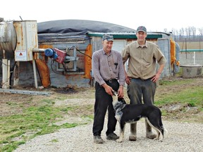 Earl Martin and his son Stewart in front of their biodigester