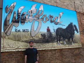 Francis Martin poses with one of his historic murals in Watford on May 27. Martin and the Arts Council of East Lambton will be holding an Art Social Event on June 21 that will include music, dancing and an art competition. Watford-area teenagers will also be creating a four-panel historical mural throughout the day.