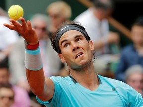 Rafael Nadal prepares to serve the ball to Dusan Lajovic during their men's singles match during the French Open at the Roland Garros stadium in Paris June 2, 2014. (REUTERS/Jean-Paul Pelissier)