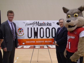 Andrew Swan, the NDP cabinet minister for Manitoba Public Insurance, stands with University of Winnipeg president Lloyd Axworthy and Wes Lee Coyote, the school's mascot on June 2, 2014 in Winnipeg. MPI will offer specialty licence plates featuring the U of W to motorists. (JIM BENDER/WINNIPEG SUN)