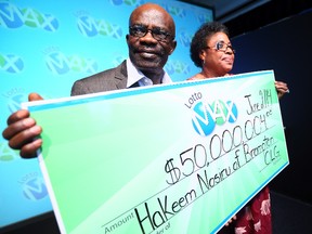 Hakeem Norisu and wife Abiola Hakeem, of Brampton, claim their $50-million Lotto Max prize at the OLG offices in Toronto on Monday, June 2, 2014. (Dave Abel/Toronto Sun)