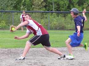 Jordan Connors of Bishop Alexander Carter is safe at second as Matt Kuzenko of St. Charles College reaches to make the catch during the high school division a slo-pitch championship game from Centennial Field in Hanmer on Monday afternoon.