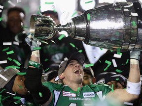 Kingston native Mike McCullough of the Saskatchewan Roughriders celebrates with the Grey Cup following his team's 45-23 victory over the Hamilton Tiger-Cats in the 101st Grey Cup game at Mosaic Stadium in Regina on Nov. 24, 2013. (Jeff Gross/Getty Images)