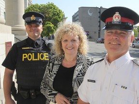 OPP Const. Mark Wellwood, left, Wiebke Wilkens, president of Kingston Partners for a Safe Community, and Kingston Police Staff Sgt. Jody Armstrong were on hand Monday morning for the launch of a new campaign to target distracted driving. MICHAEL LEA\THE WHIG STANDARD