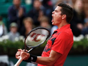 Milos Raonic celebrates after winning his men's singles match against Marcel Granollers at the French Open in Paris, June 1, 2014. (VINCENT KESSLER/Reuters)