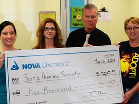 Nova Chemicals presents a $5,000 cheque to the Sarnia and District Humane Society. From left, Nichole Workman and Tracy Tiernay of Nova Chemicals, and George Vandenberg and Donna Payette of the Humane Society.