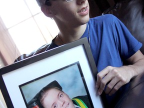 Brad Perrott, recipient of the E.C. McTavish Award sits with a photograph of brother Ty who passed away last year. Perrott who suffers from cerebral palsy, received the award, unexpectedly for the high school senior, for excellence in school while overcoming obstacles. ELENA MAYSTRUK/ AGE DISPATCH/ QMI AGENCY