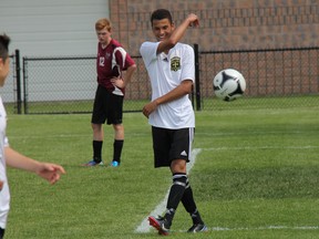 Holy Cross' Chad Gopaul (right) celebrates with Ethan Vigario (with his back to camera) during the May 27 TVRA championships in Strathroy. Centurion boys won 4-0 and girls won 5-0 against North Middlesex D.H.S. Both teams go on to OFSAA today. Boys host in London and girls travel to Windsor. ELENA MAYSTRUK/ AGE DISPATCH/QMI AGENCY