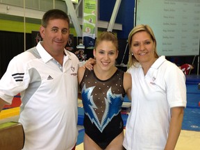 Bluewater Gymnastics coaches Dave Brubaker, left, and Liz Brubaker, right, pose with Dominique Pegg after she qualified for the Canadian Olympic team Thursday, June 28, 2012 in Gatineau, Que. Dave Brubaker will be joining Pegg in the Olympic village after he was named a coach for the Canadian women's artistic gymnastics team at the London 2012 games.  (Submitted photo)