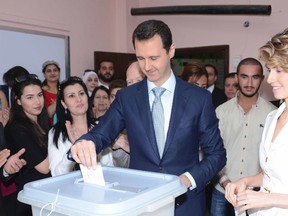 Syria's President Bashar al-Assad and his wife Asma cast their votes in the country's presidential elections.

REUTERS/SANA/Handout via Reuters