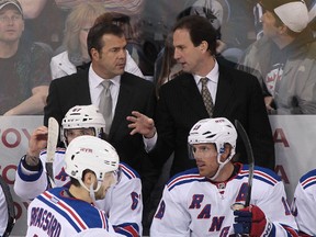 Head coach Alain Vigneault (L) of the New York Rangers and associate coach Scott Arniel talk on the bench in first-period action against the Winnipeg Jets at the MTS Centre on March 14, 2014 in Winnipeg, Manitoba, Canada. Both Vigneault and Arniel were head coaches of the AHL's Manitoba Moose. Arniel also played with both the original Winnipeg Jets and the Manitoba Moose.  Marianne Helm/Getty Images/AFP