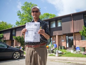 Farooq Chishti holds a copy of his water bill Tuesday outside his Summit Ave. home in London. Chishti has been trying for years to collect money from his neighbours to pay the bill after discovering the adjoining units share his waterline. (CRAIG GLOVER, The London Free Press)