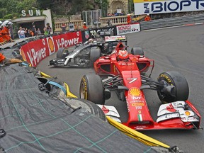 Ferrari’s Kimi Raikkonen drives ahead of McLaren Mercedes’ Kevin Magnussen at the Monaco Grand Prix. (AFP)