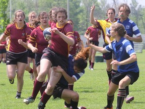 A Regiopolis-Notre Dame Panthers ball carrier tries to elude St. Jean de Brebeuf tacklers during a consolation-round game at the OFSAA girls  rugby AAA championship in Hamilton on Tuesday. (Gerry Graham/OFSAA)