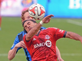 Toronto FC’s Dwayne De Rosario battles for the ball with Montreal Impact’s Wandrille Lefevre during last week’s 1-1 draw. (USA TODAY SPORTS)