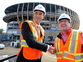 Quebecor Media CEO Pierre Dion (left) and Quebec City mayor Regis Labeaume shake hands on Tuesday in front of what will eventually be Quebecor Arena. (Jean-Francois Desgagnes/QMI Agency)