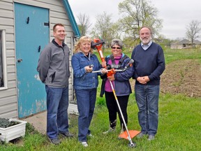 The West Perth Co-op Garden is ready for the growing season. Despite recent wet, cool weather, organizers are hoping Mother Nature cooperates in the coming weeks as local residents begin to plant, flowers, fruits and vegetables. This year, gardeners will have some help preparing their plots with a brand new weed wacker (seen here), donated by Farm Credit Canada and the Rotary Club of Mitchell. From left are incoming Rotary Club President Mike Kraemer, Patty Kehl and Brenda Hinz of the West Perth Co-op Garden, and Rotary Club President John Hohner.  KRISTINE JEAN/MITCHELL ADVOCATE