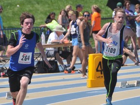 James Cooper (right) turns the corner during the midget boys 200m race. SUBMITTED