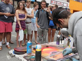 Chris Seaton, of London's Spraypaint Creations, creates a painting at the 2013 Artwalk in downtown Sarnia. The 29-year-old drew crowds with speedy live demonstrations, finishing paintings in mere minutes. (File photo)