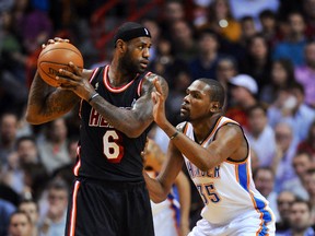 Miami Heat small forward LeBron James is pressured by Oklahoma City Thunder small forward Kevin Durant during the first half  at American Airlines Arena on Jan. 29, 2014. (Steve Mitchell/USA TODAY Sports)