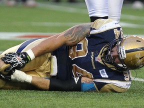 Winnipeg Blue Bombers DE Ryan Lucas grabs his knee during CFL action against the Calgary Stampeders from Investors Group Field on Fri., July 26, 2013. Lucas injured his knee again Monday and is out for the season. KEVIN KING/Winnipeg Sun/QMI Agency