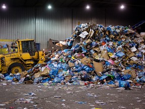 FILE: Crews work at the Materials Recovery Facility at the Edmonton Waste Management Centre, 13111 Meridian Street, in Edmonton, Alta., on Friday Dec. 27, 2013. The City of Edmonton held a press conference at the facility to remind residents of what is and isn't recyclable after Christmas. David Bloom/Edmonton Sun